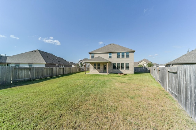 rear view of house with a patio area and a yard