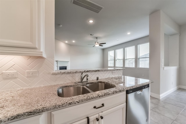 kitchen with dishwasher, sink, white cabinetry, and backsplash