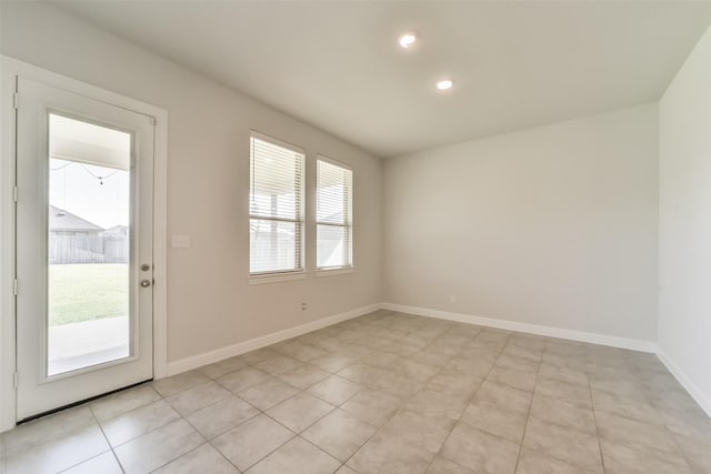 tiled empty room featuring a healthy amount of sunlight