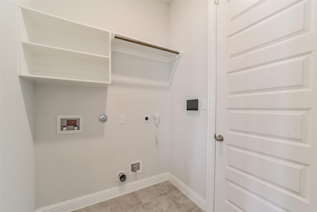 clothes washing area with hookup for a washing machine, light tile patterned floors, gas dryer hookup, and electric dryer hookup