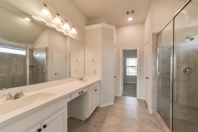 bathroom featuring tile patterned flooring, vanity, walk in shower, and vaulted ceiling