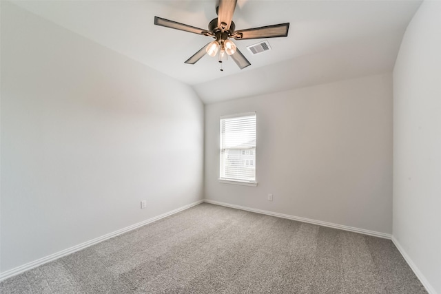 carpeted spare room featuring ceiling fan and vaulted ceiling