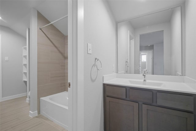 bathroom with vanity and tiled shower / bath combo