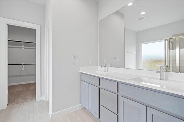 344 Spruce Oak Ln, Waller, TX 77484 - full bath featuring a stall shower, double vanity, a walk in closet, and baseboards