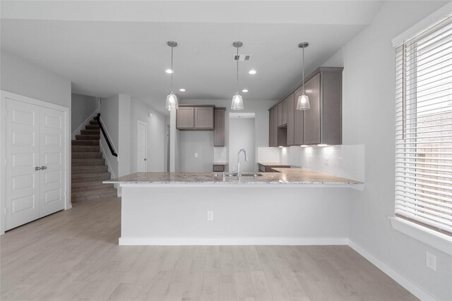 344 Spruce Oak Ln, Waller, TX 77484 - kitchen with a peninsula, a sink, plenty of natural light, light wood-style flooring, and recessed lighting