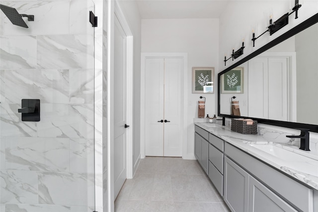 bathroom featuring tiled shower, vanity, and tile patterned floors