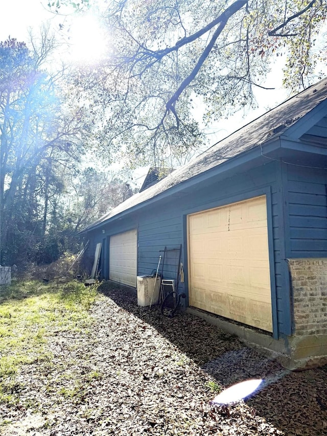 view of home's exterior featuring an outbuilding and a garage