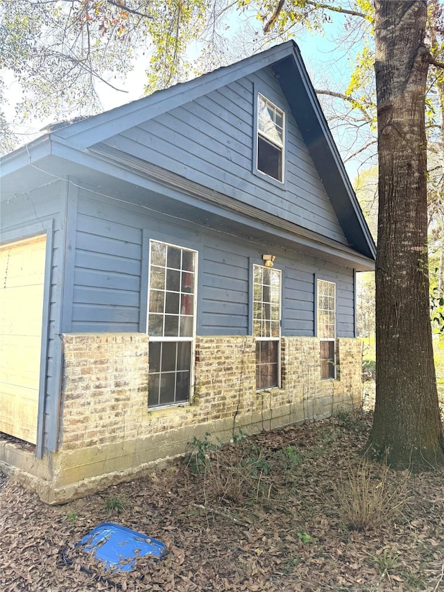 view of side of home featuring a garage