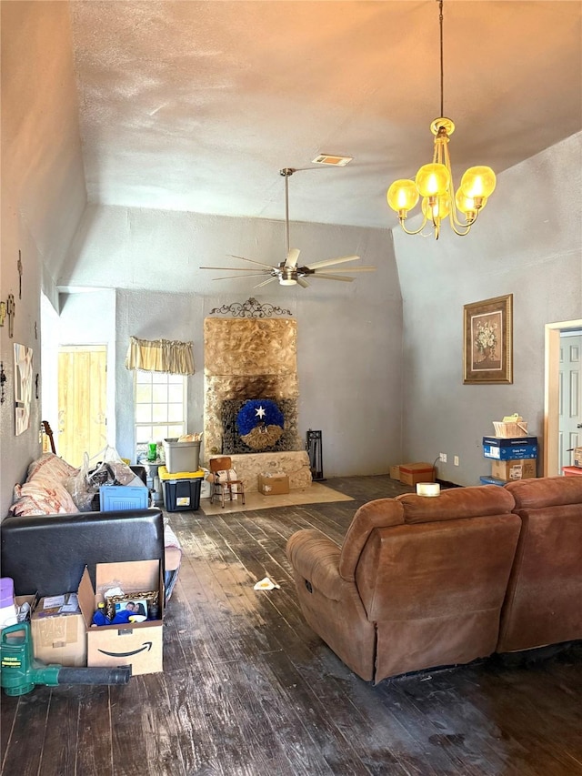 living room featuring a textured ceiling, hardwood / wood-style floors, ceiling fan with notable chandelier, and vaulted ceiling