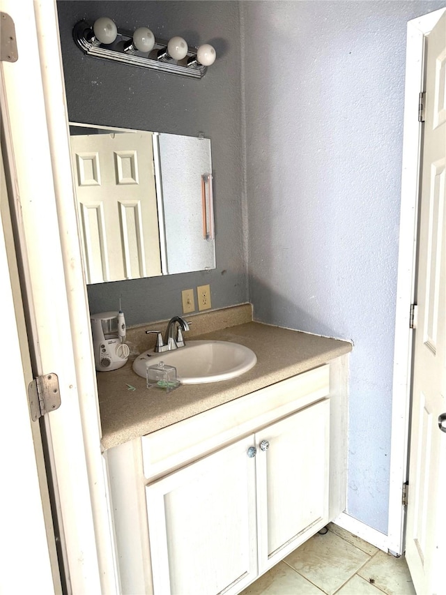 bathroom featuring tile patterned flooring and vanity