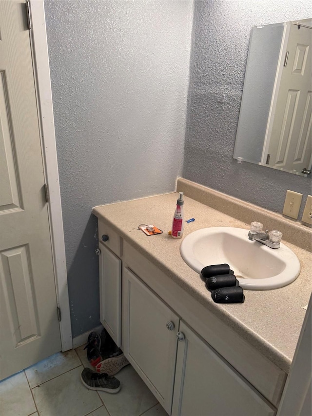 bathroom with tile patterned floors and vanity