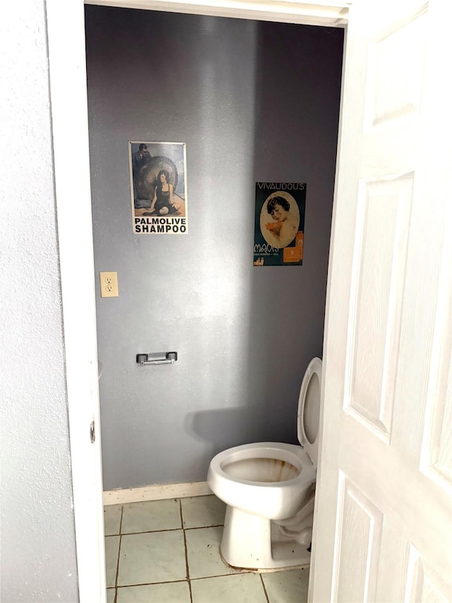 bathroom with tile patterned flooring and toilet