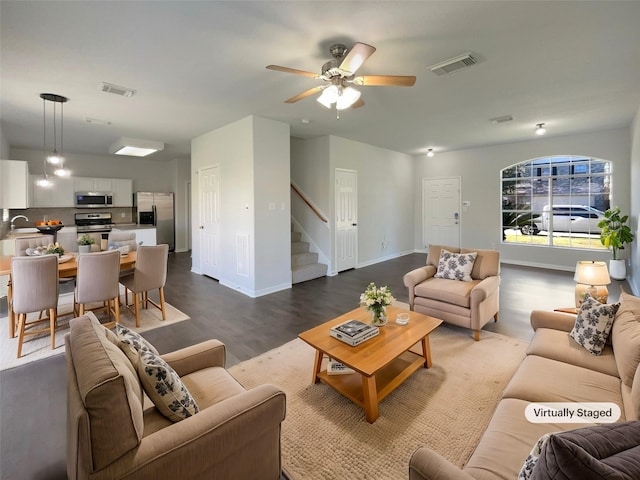 living room with ceiling fan, sink, and hardwood / wood-style flooring