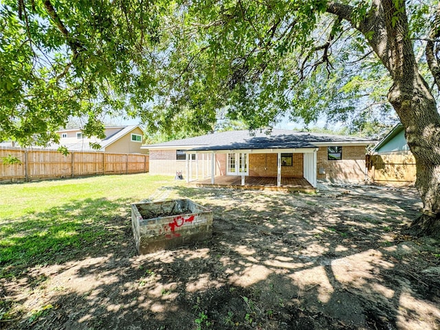 rear view of property with a yard and french doors