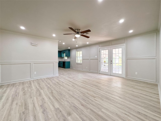 unfurnished living room with ceiling fan, french doors, light hardwood / wood-style floors, and ornamental molding