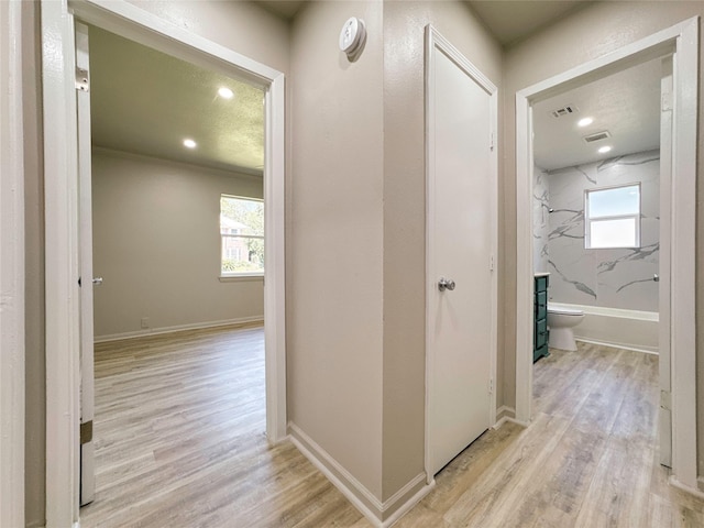 hallway with light hardwood / wood-style flooring