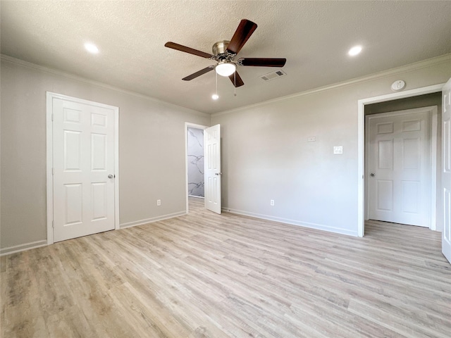 unfurnished bedroom with ceiling fan, light hardwood / wood-style flooring, a textured ceiling, and ornamental molding