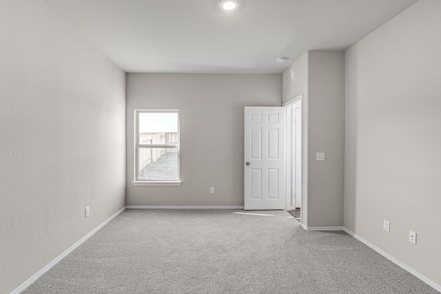 empty room with light colored carpet