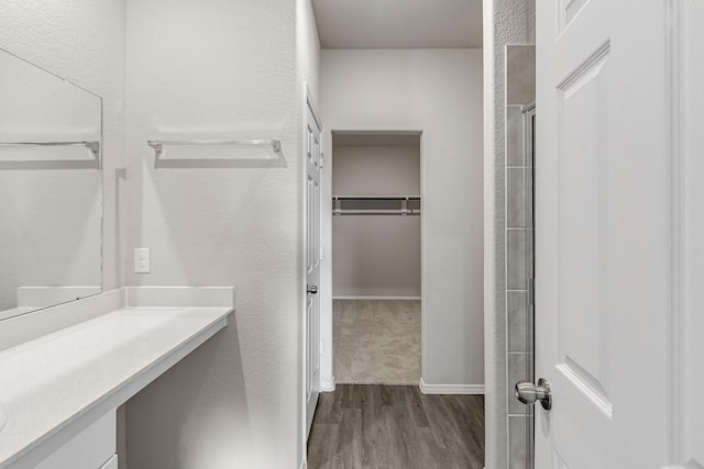 bathroom with vanity, wood-type flooring, and an enclosed shower