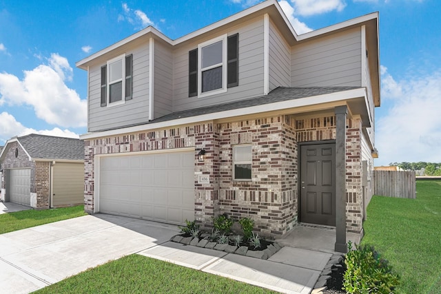 view of front of property featuring a front yard and a garage