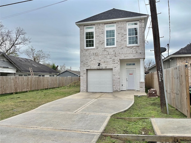 view of front facade with a garage and a front yard