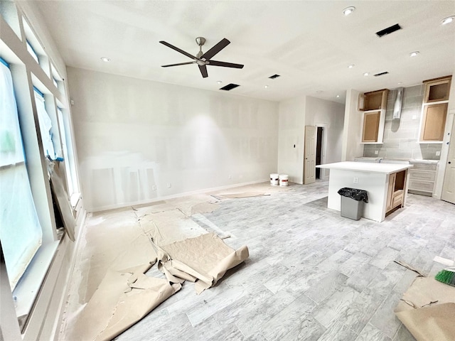 kitchen with ceiling fan and a center island