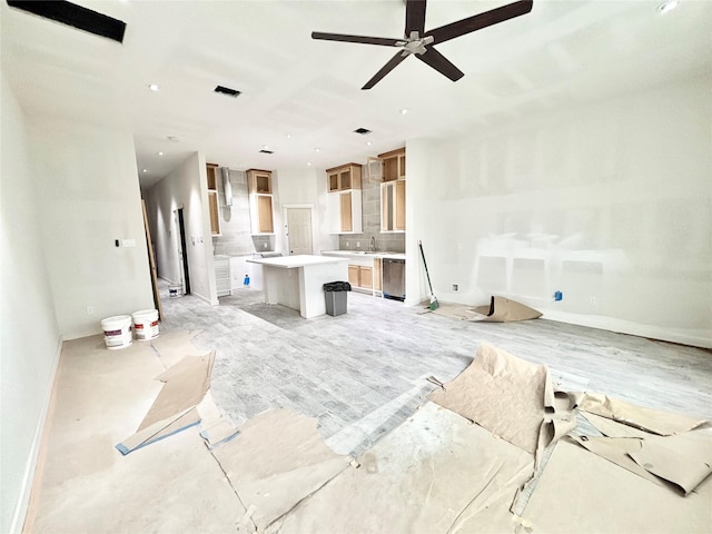 living room featuring ceiling fan and sink