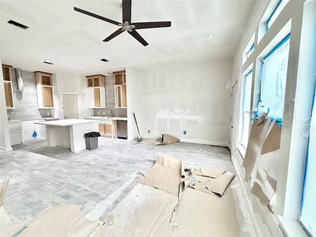 living room featuring ceiling fan and sink