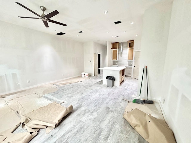 living room featuring ceiling fan and light wood-type flooring