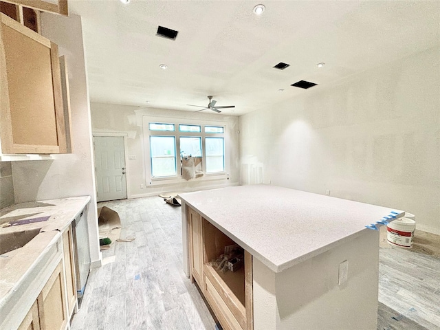 kitchen featuring light brown cabinetry, ceiling fan, and light hardwood / wood-style flooring