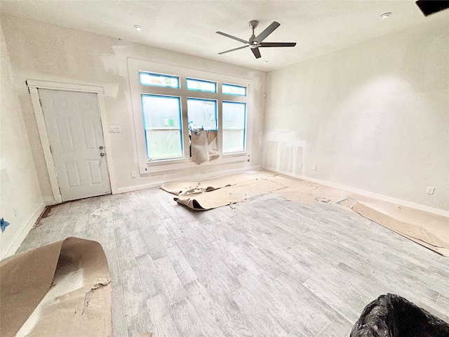 unfurnished room with ceiling fan and hardwood / wood-style flooring