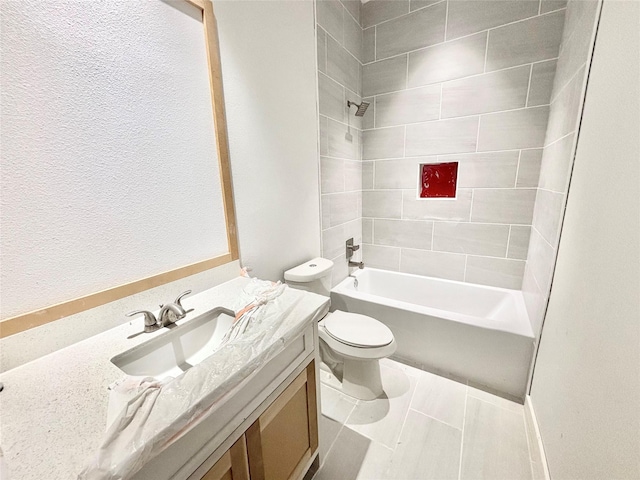 full bathroom featuring tile patterned floors, vanity, toilet, and tiled shower / bath combo