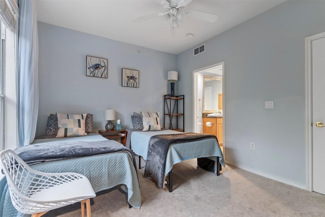 carpeted bedroom featuring ceiling fan and ensuite bathroom