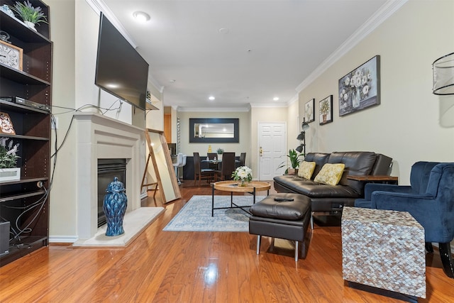 living room featuring ornamental molding and light hardwood / wood-style flooring