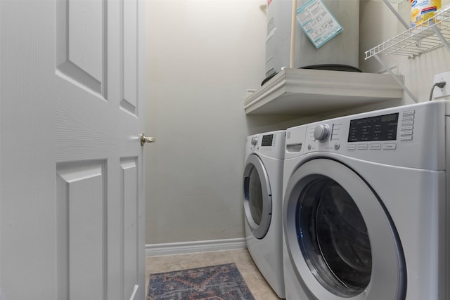 washroom featuring cabinets, light tile patterned flooring, and independent washer and dryer