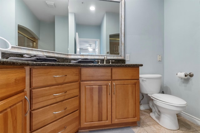 bathroom featuring toilet, vanity, tile patterned flooring, and ceiling fan