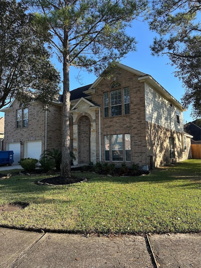 view of front of home with a garage and a front yard