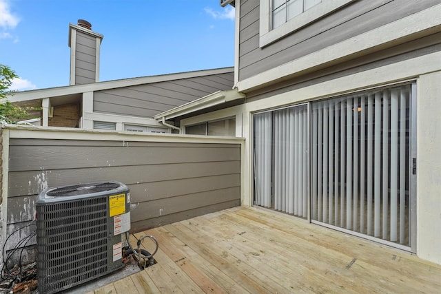 wooden deck featuring central AC unit