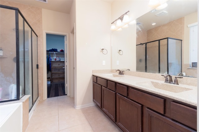 bathroom featuring tile patterned floors, vanity, and walk in shower