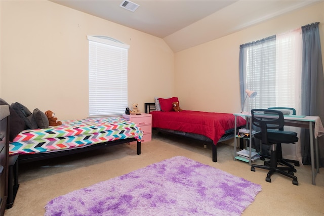 bedroom featuring carpet floors and vaulted ceiling