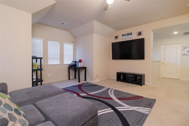 living room with ceiling fan, lofted ceiling, and light carpet