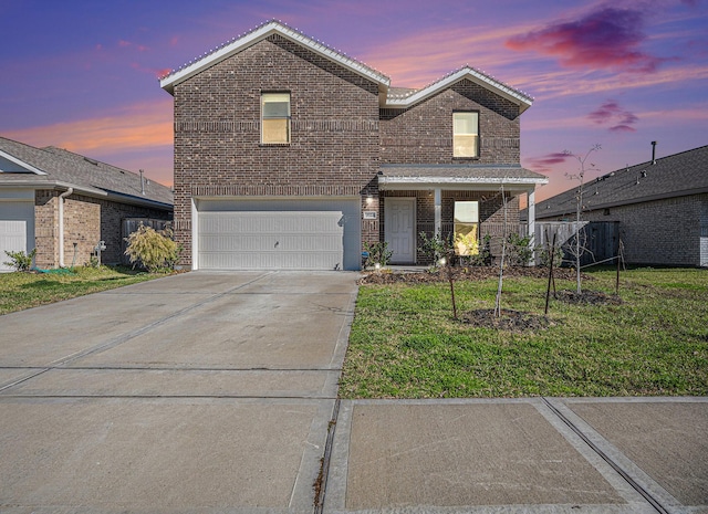 view of property featuring a garage and a yard