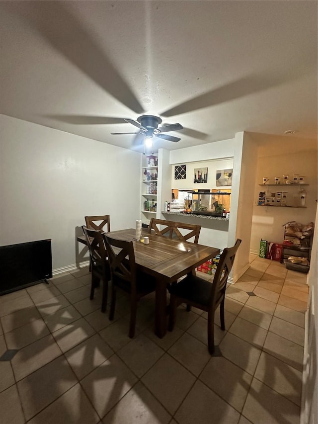 dining area with tile patterned flooring and ceiling fan