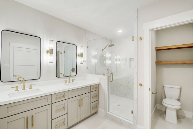 bathroom with tile patterned floors, toilet, vanity, and walk in shower