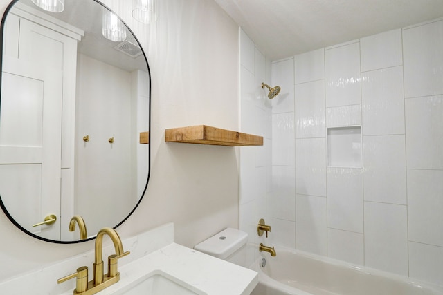 full bathroom featuring vanity, toilet, and tiled shower / bath