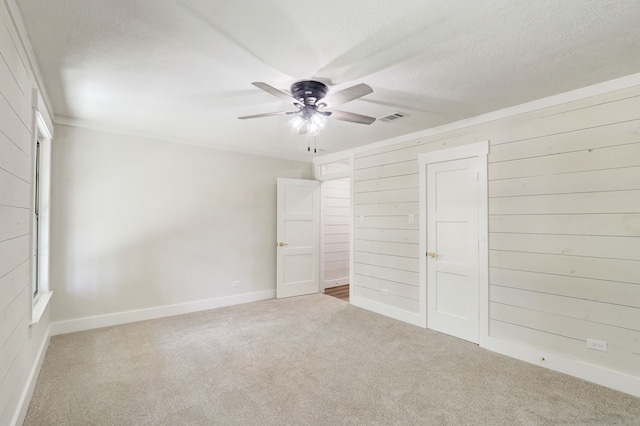 unfurnished bedroom featuring ceiling fan, carpet floors, and a textured ceiling