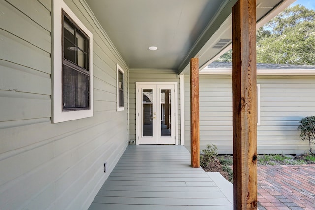 doorway to property featuring covered porch and french doors