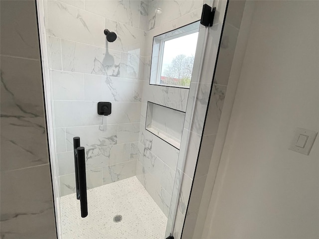 bathroom with a shower with shower door