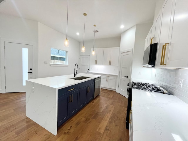 kitchen with white cabinetry, sink, decorative light fixtures, and appliances with stainless steel finishes