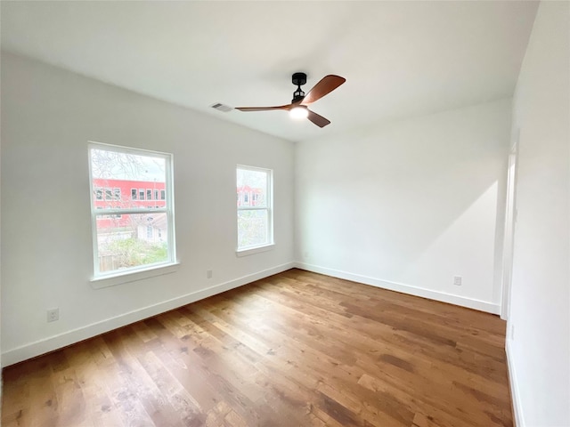 spare room featuring wood-type flooring and ceiling fan